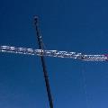 Tower crane rental arm being lifted up for setup