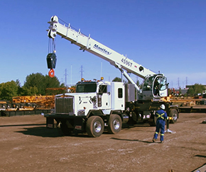 White boom truck at a site