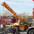 Broderson crane using part to lift box