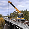 Orange Maeda Crawler Crane on bridge