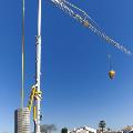 Potain crane with base parts on construction site