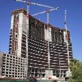 Three Terex cranes with limit switch parts working on a building