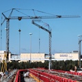 Two self erecting crane rentals working on site