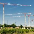 Four flat top tower crane rentals working on site