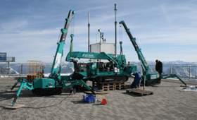 Maeda Cranes Lined Up On Building